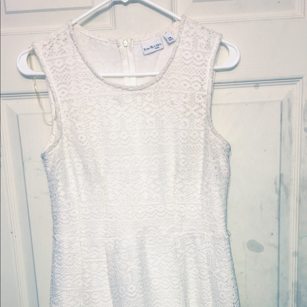 A white, lace designed child’s dress